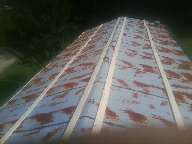 Rusted metal roof panels with new wood purlins before replacement — Storm Damage Roof Repair in Healdsburg by Roofing Brothers